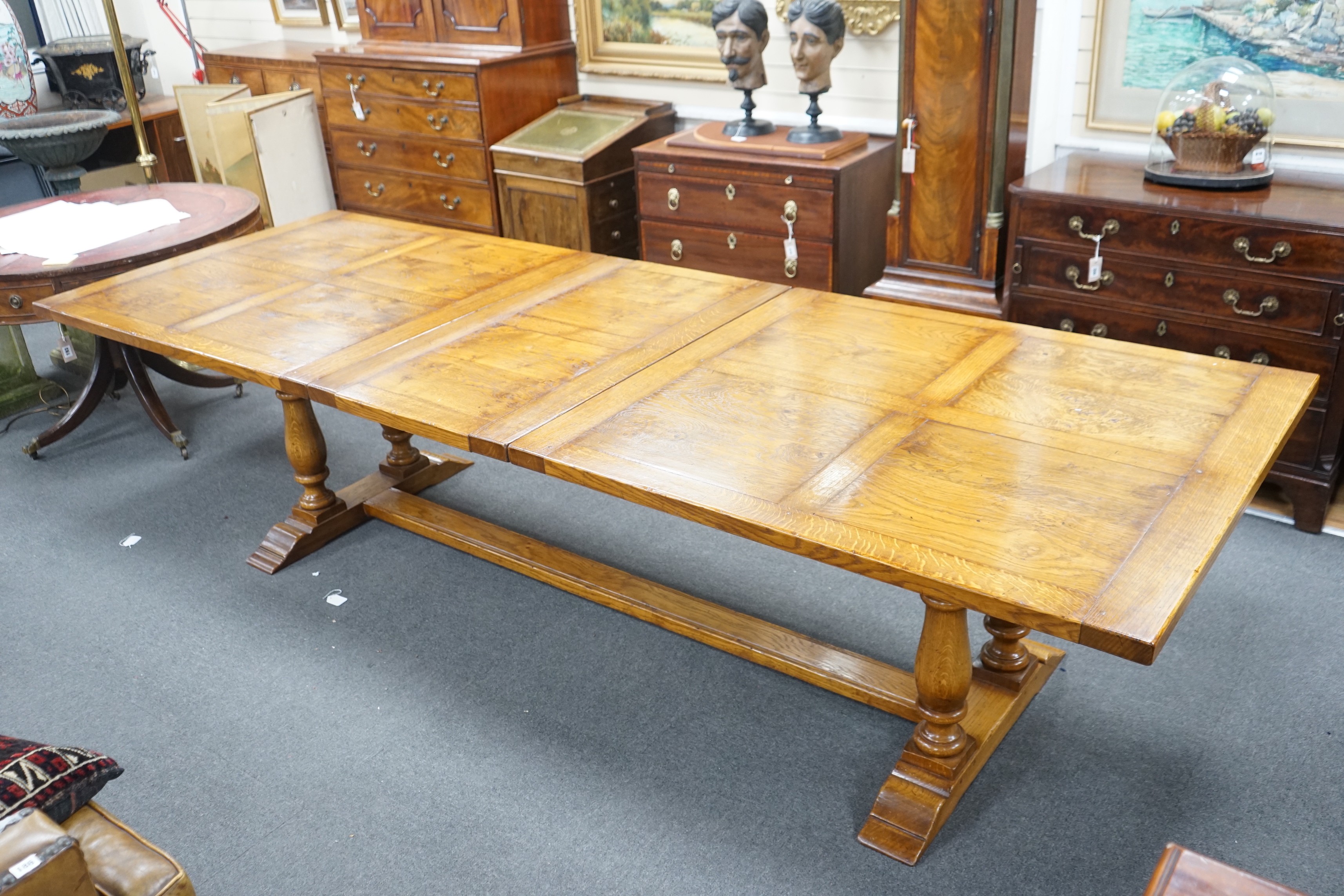 A reproduction 18th century style oak extending refectory dining table, length 306cm extended, one spare leaf, width 106cm, height 75cm